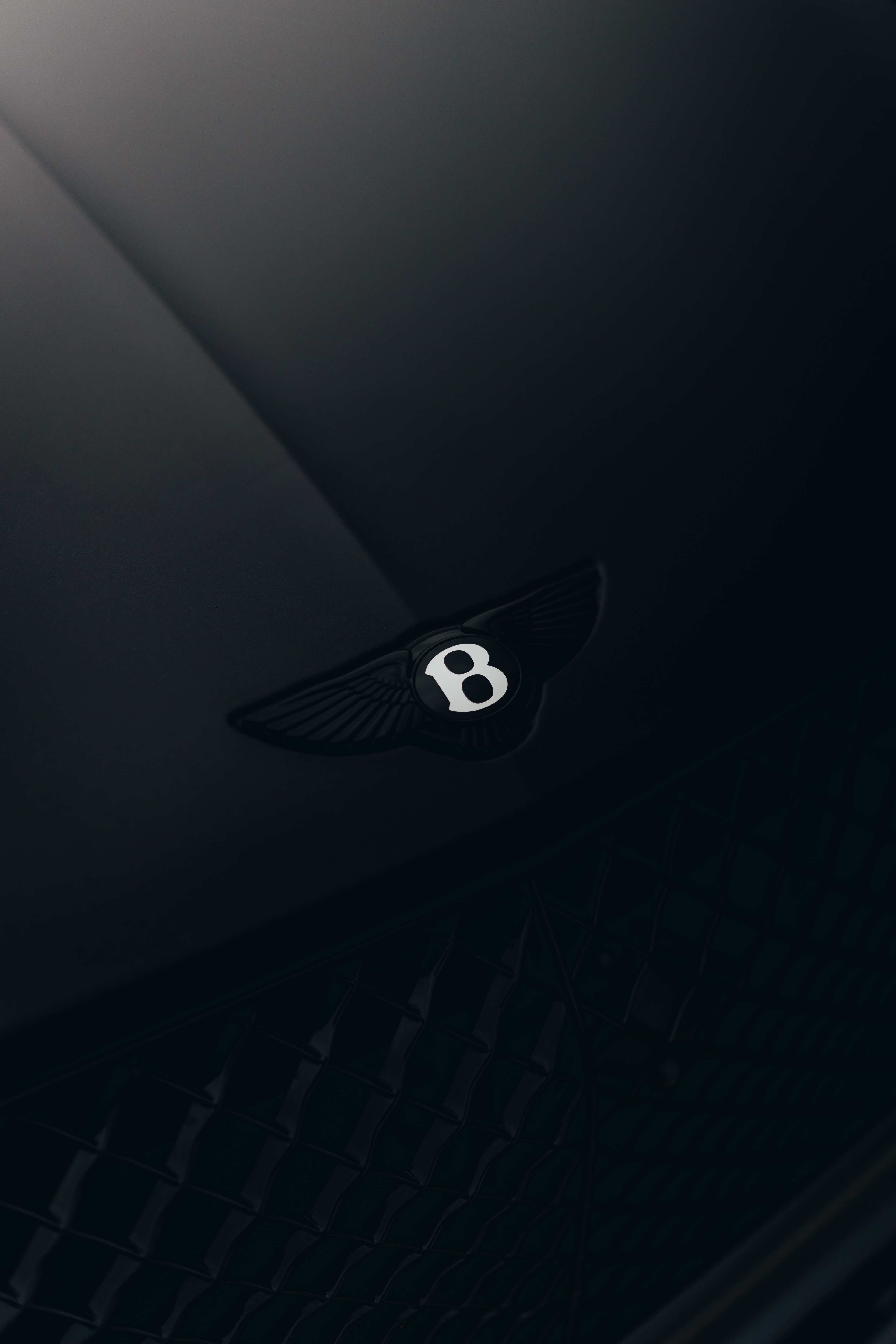 Bentayga matte-black hood — Bentley wings badge on black