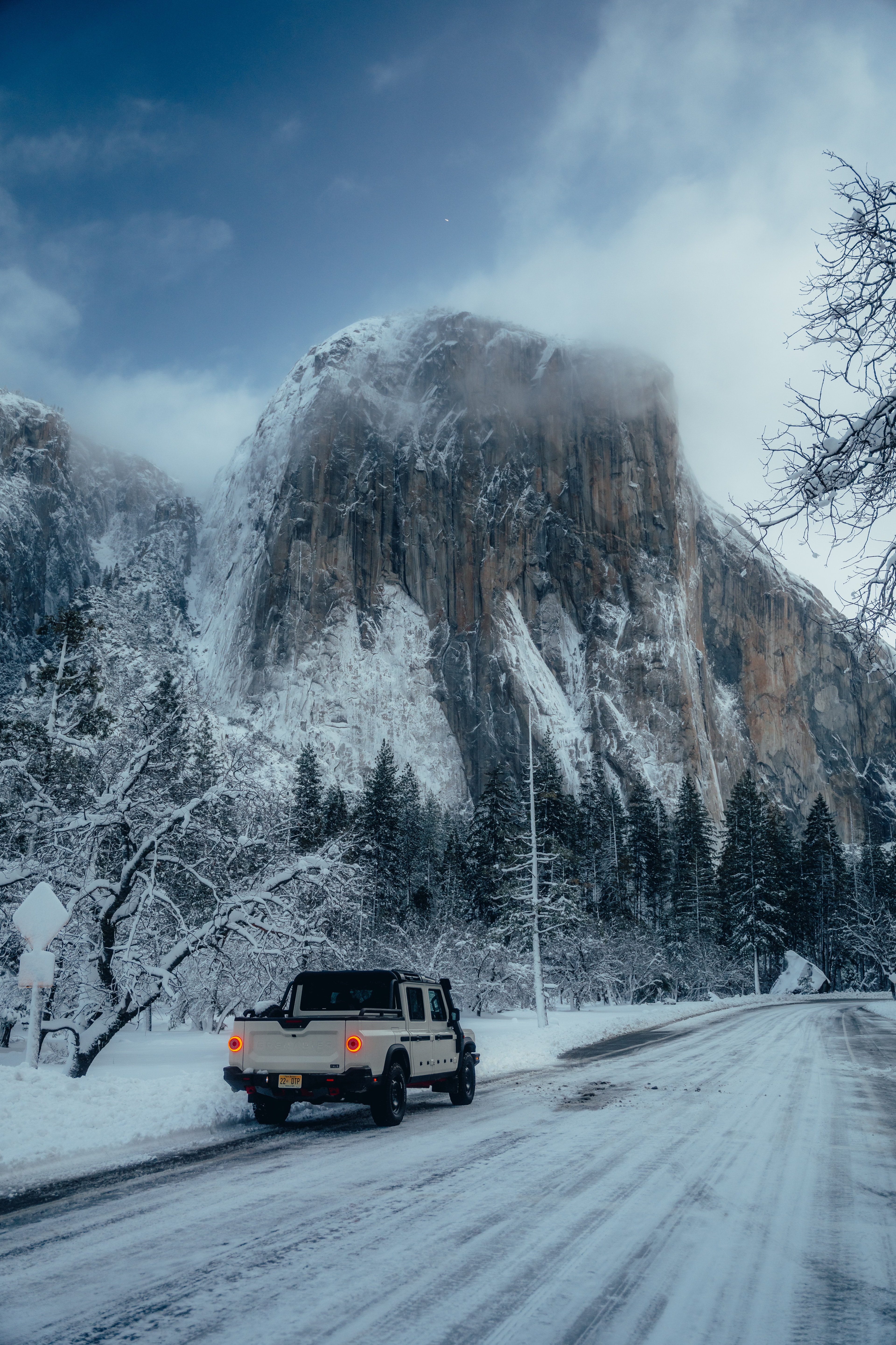 INEOS Grenadier Quartermaster rear three-quarter, El Capitan towering over the snowy valley