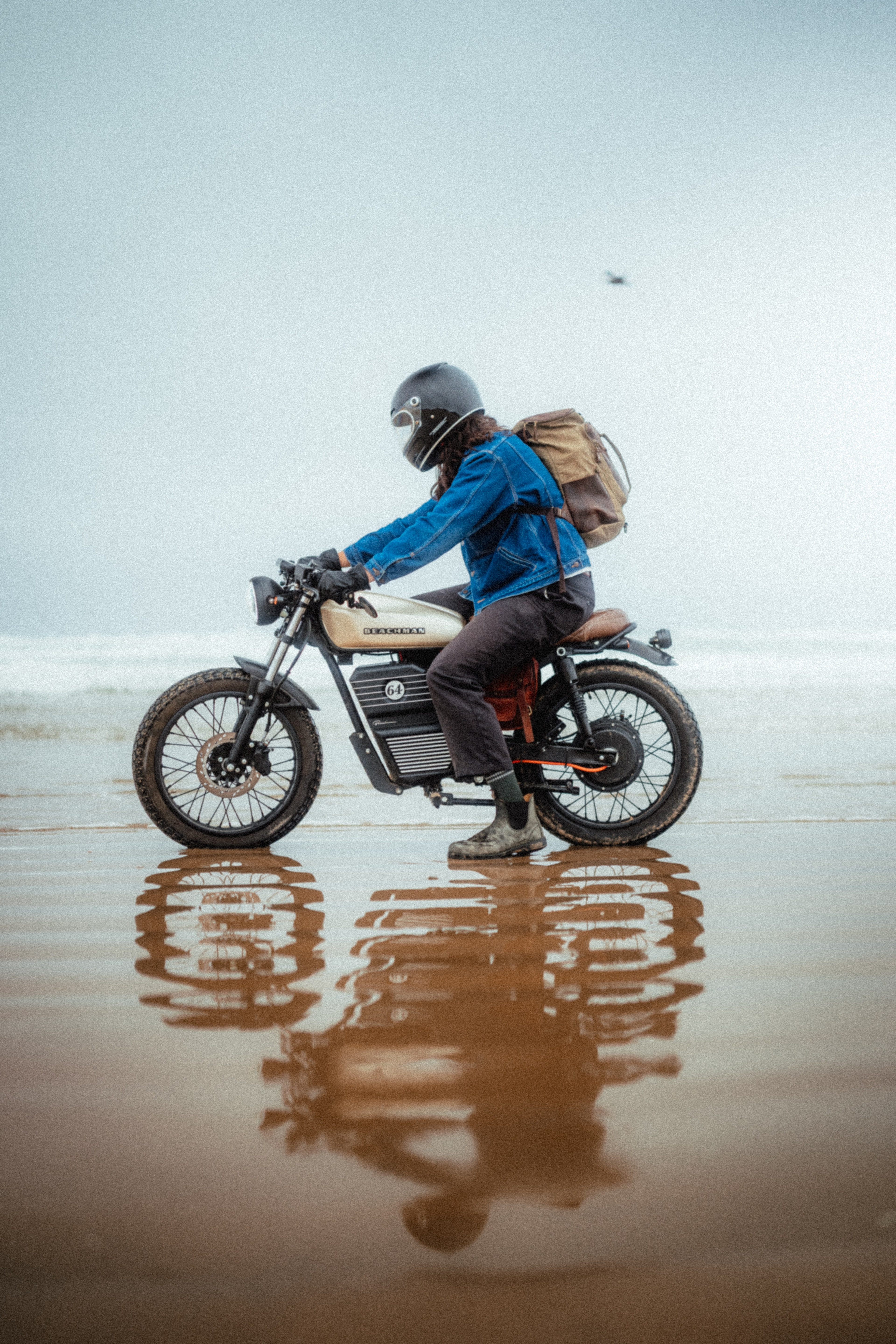 Beachman cafe racer side profile on the wet beach, mirrored in the sand