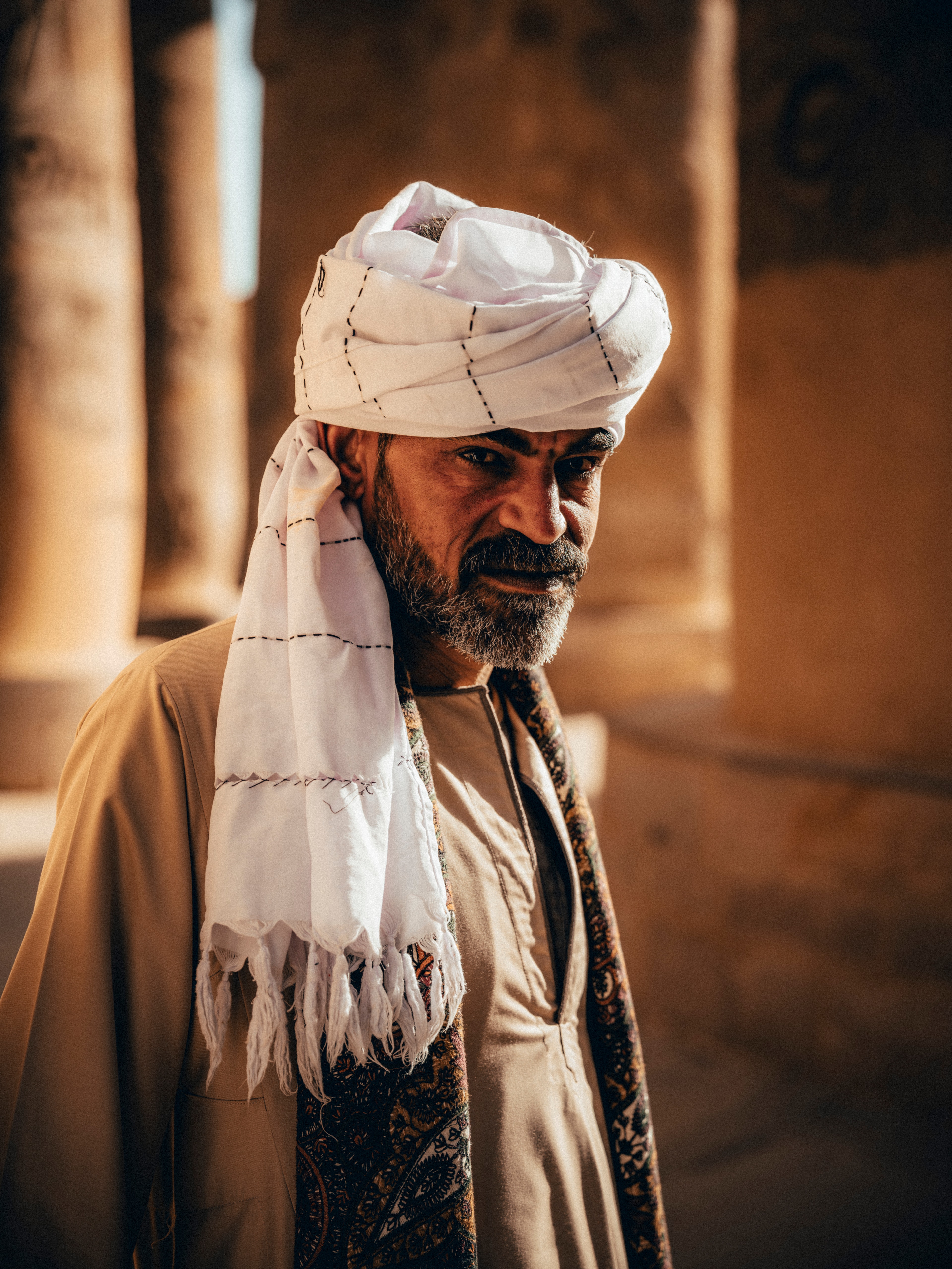 Portrait of an Egyptian elder in a white keffiyeh turban and patterned scarf