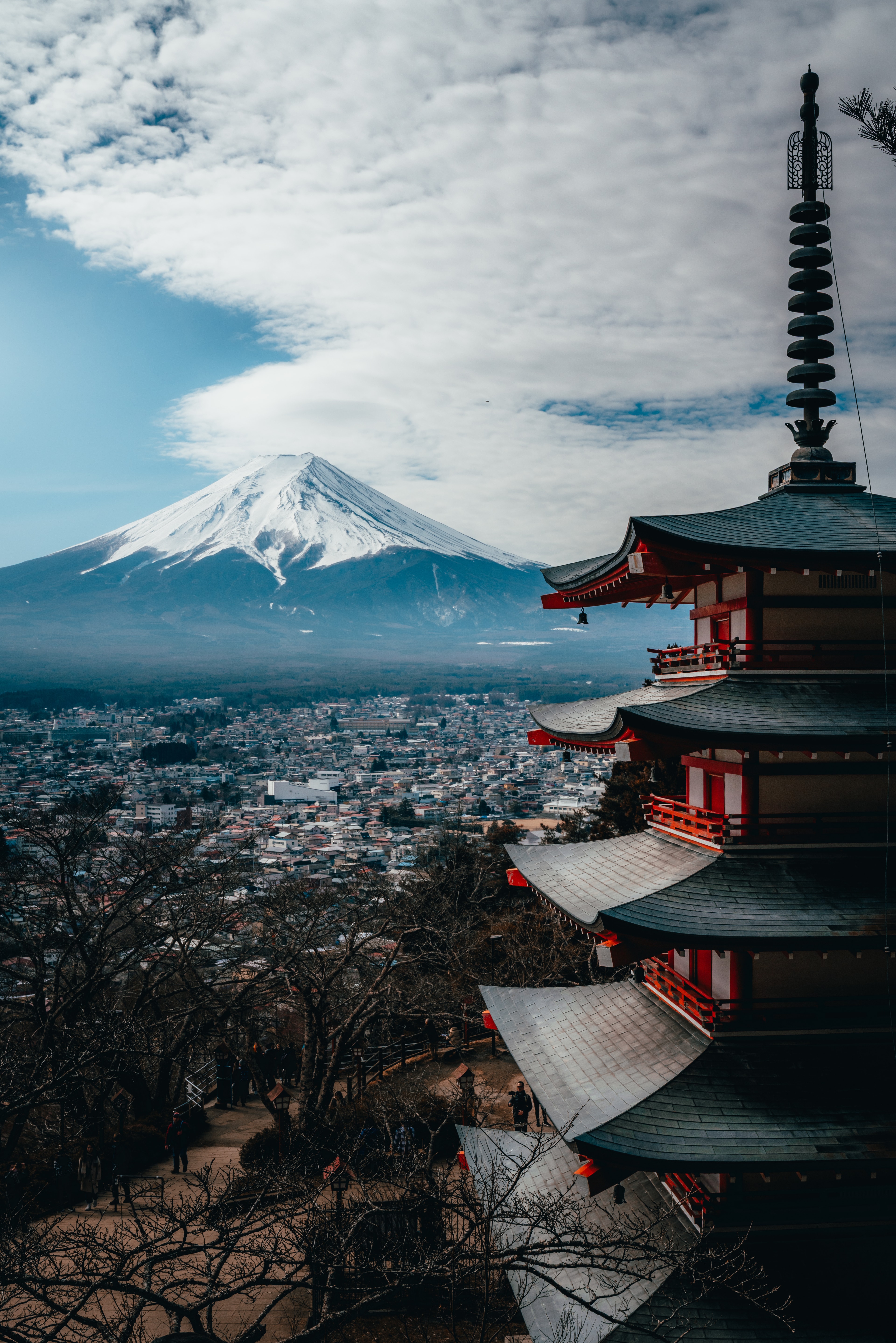 The Chureito pagoda with Mt Fuji rising behind it under moody cloud